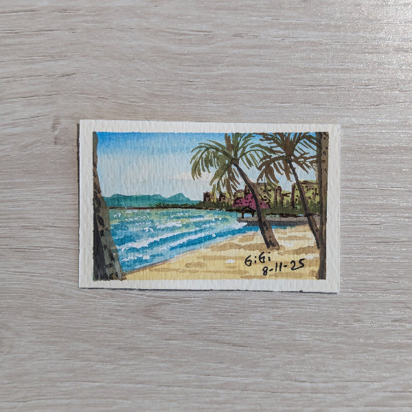 Miniature painting of a beach scene with palm trees on a textured surface