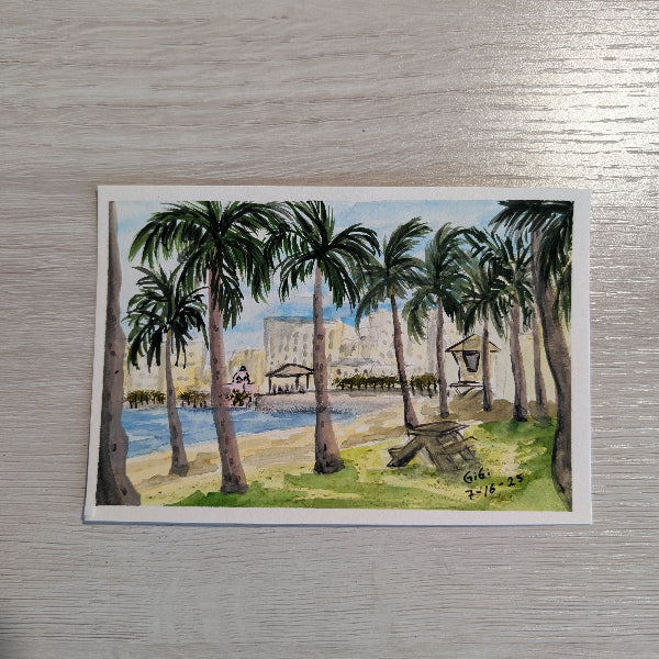 Painting of a beach scene with palm trees on a watercolor postcard