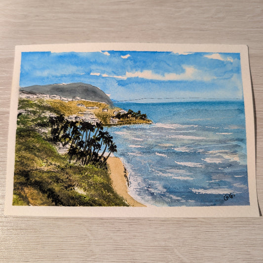 Painting of a coastal scene with a beach, ocean, and mountains.