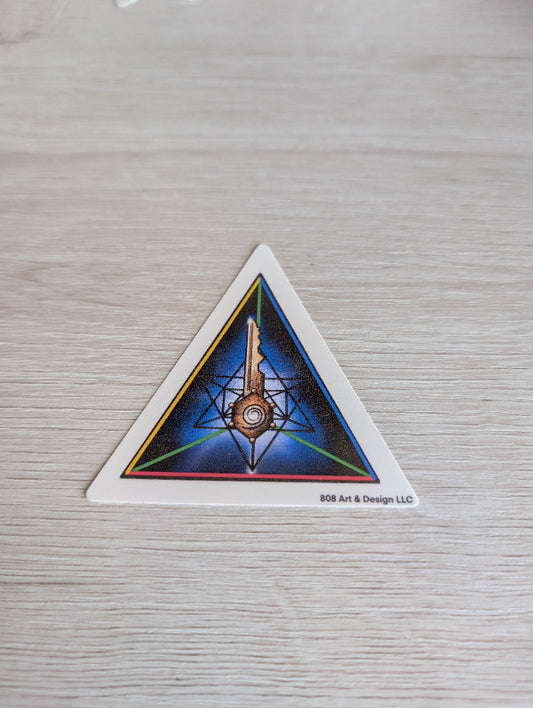 Triangular sticker with geometric design on a textured surface. the key in life is gratitude